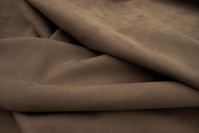 Closeup picture of soft taupe nubuck showing the texture of leather