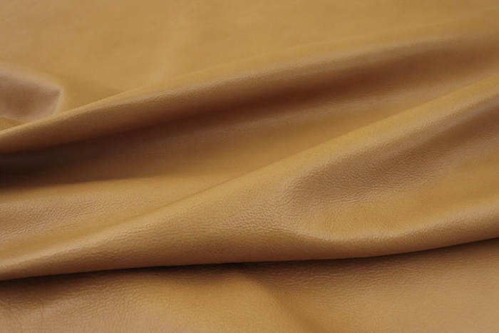 Close up picture of warm gold full grain upholstery leather