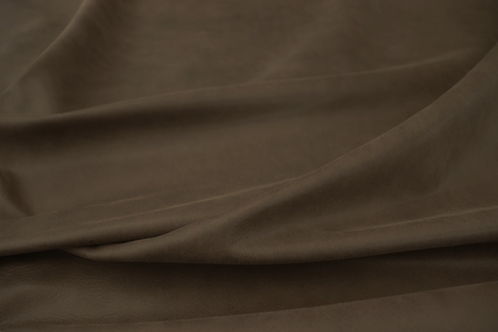 Close up picture of rich dark brown aniline upholstery leather