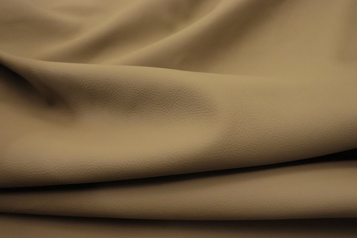 Close up of warm dark sand color Italian upholstery leather