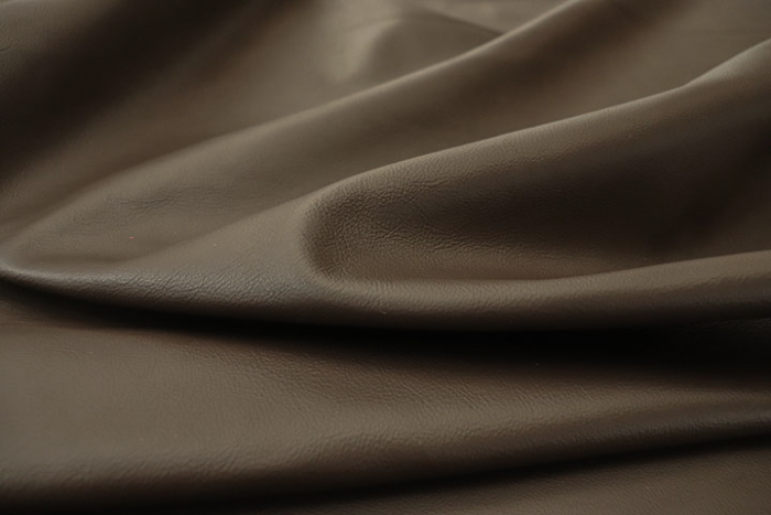 Close up picture of rich dark brown Italian leather for upholstery