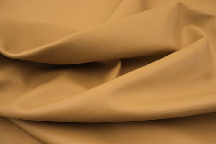 Close up of soft golden camel nappa like upholstery leather