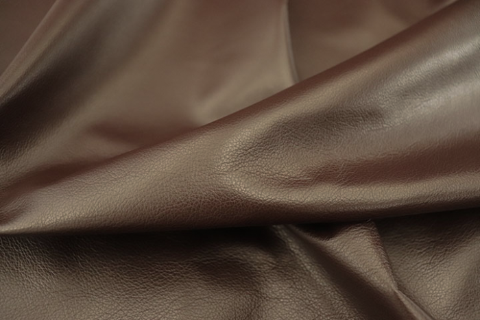 Close up picture of rich plum pigmented leather for upholstery