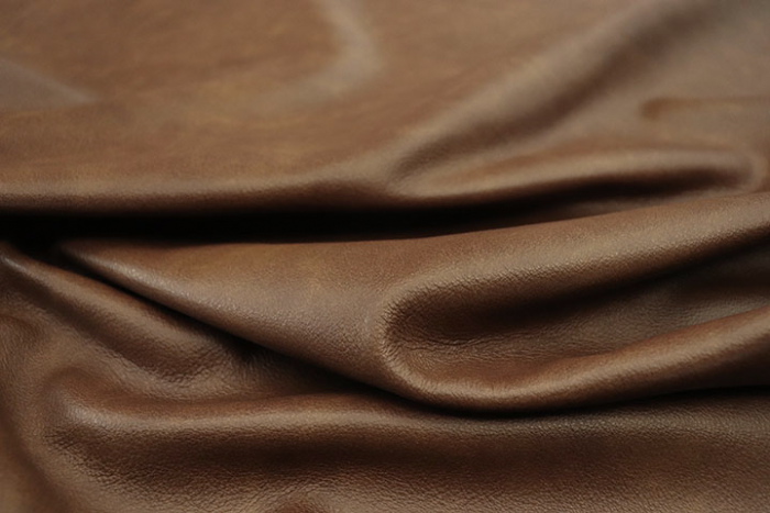 Close up picture of multitone medium brown semi aniline upholstery leather