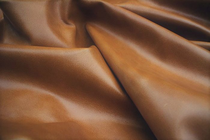 Close up picture of golden brown aniline leather for upholstery