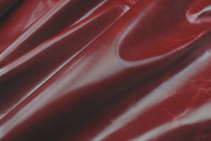 Close up picture of dark red aniline leather for upholstery