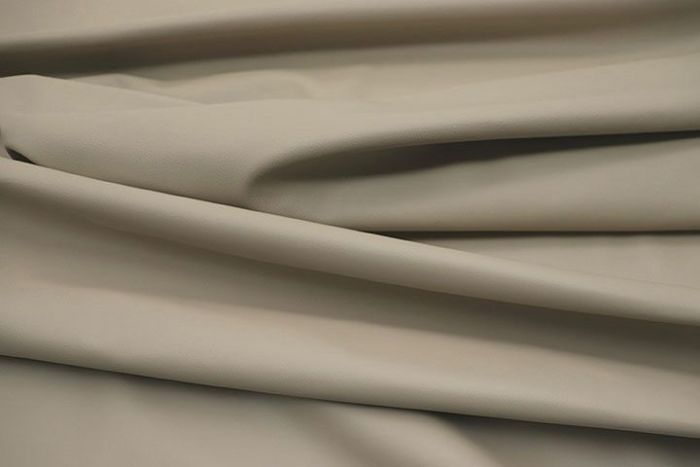 Close up picture of cream smooth grain leather for upholstery