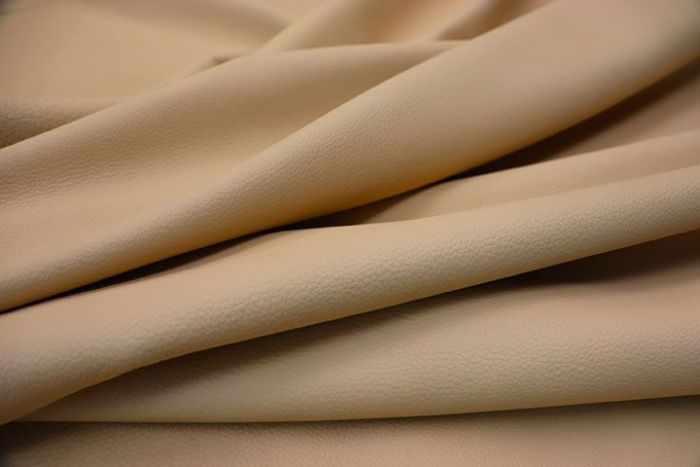 Close-up picture of Moonlight warm tan full grain leather for upholstery with pebble grain texture.