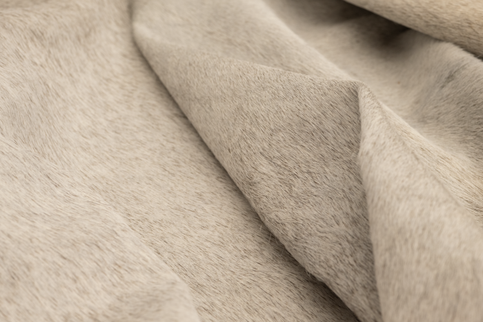 Close up of white with darker accents hair on upholstery leather