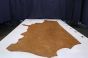 Oak brown colored vintage leather cowhide laying flat on a table 