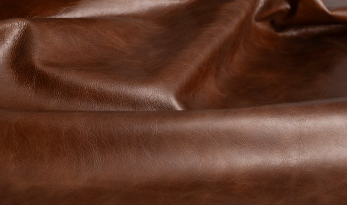 Close up of saddle brown distress upholstery leather