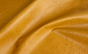 Close up of golden camel color ostrich print embossed upholstery leather