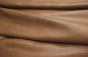 Close up picture of warm mocha natural grain leather hide 