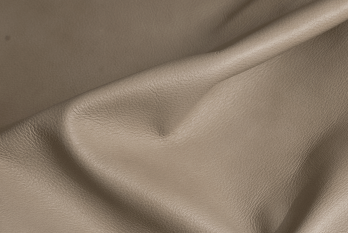 Close up of ivory taupe natural grain upholstery leather
